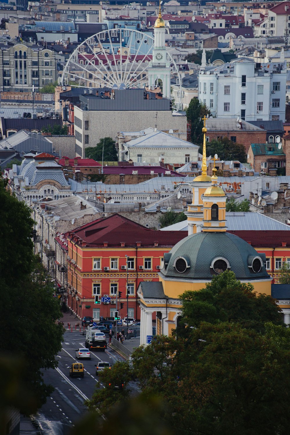 a view of a city with a ferris wheel in the background