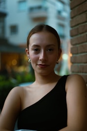 a woman in a black dress holding a bowl of food