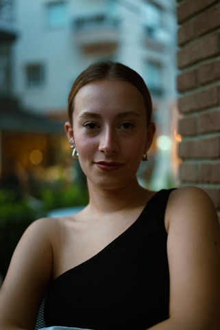 a woman in a black dress holding a bowl of food