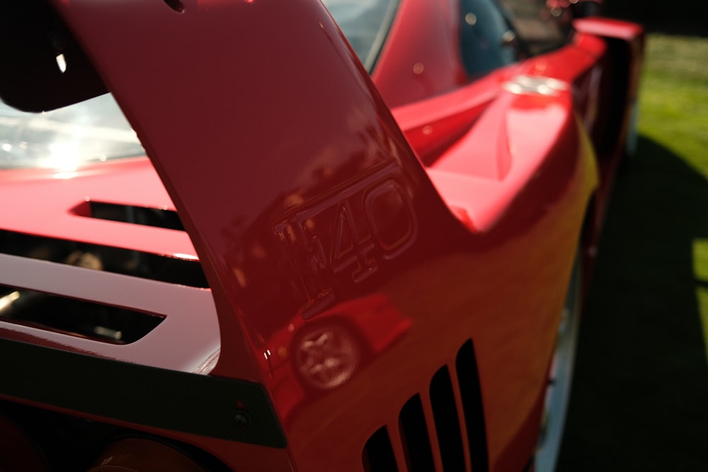 a close up of the front of a red sports car