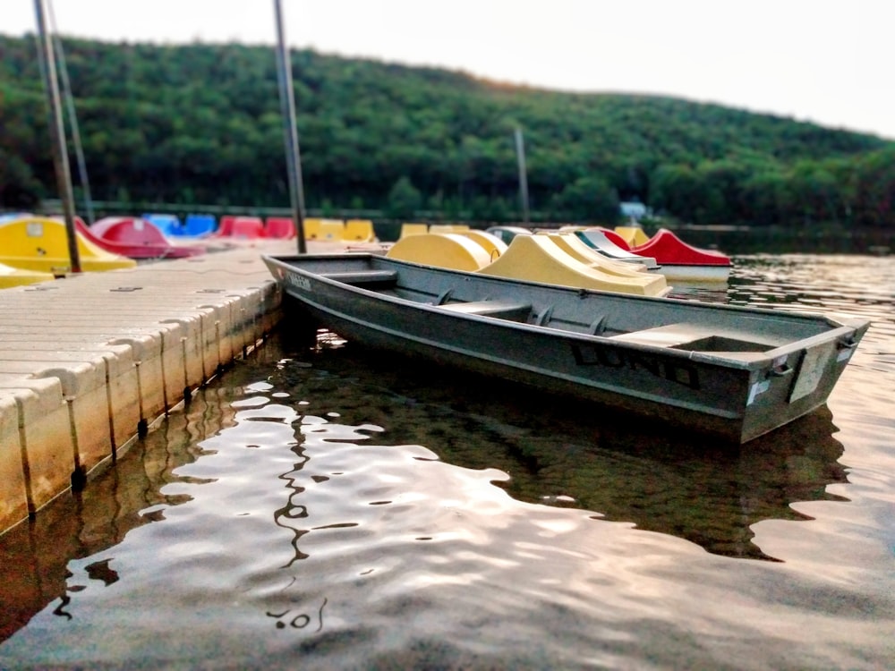 a row of boats sitting on top of a body of water