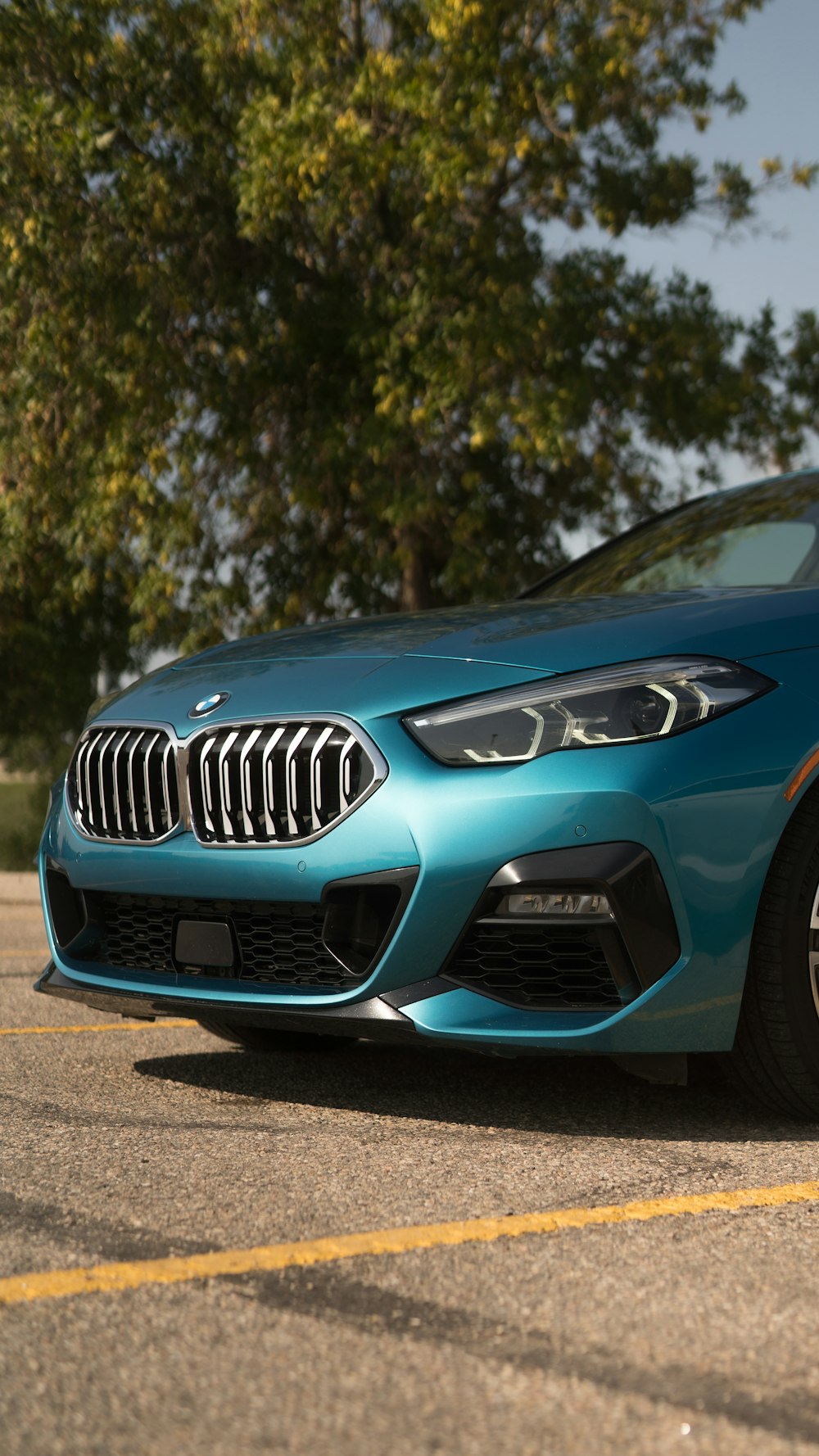 a blue bmw car parked in a parking lot