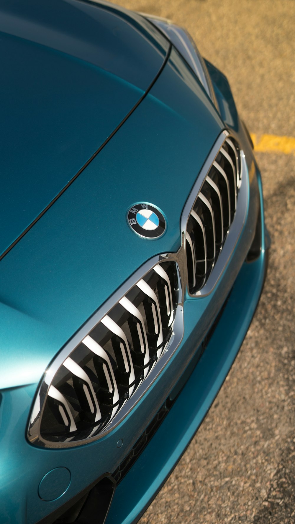 a close up of the front of a blue sports car