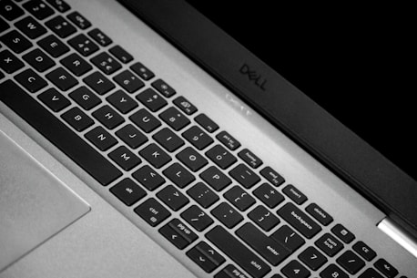 A close-up of a laptop keyboard with brand logos subtly visible, representing quality.