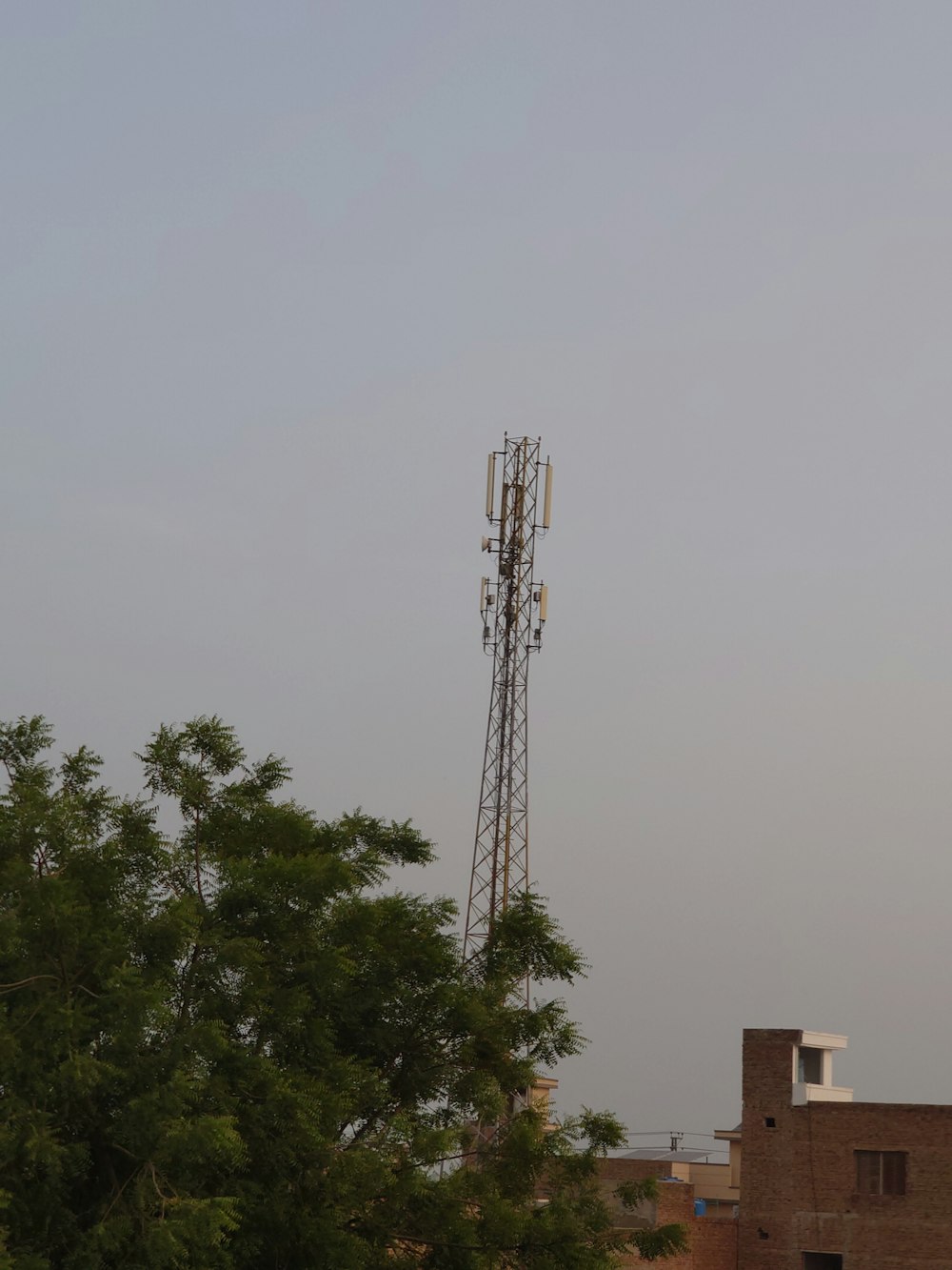 a tall tower with a cell phone on top of it