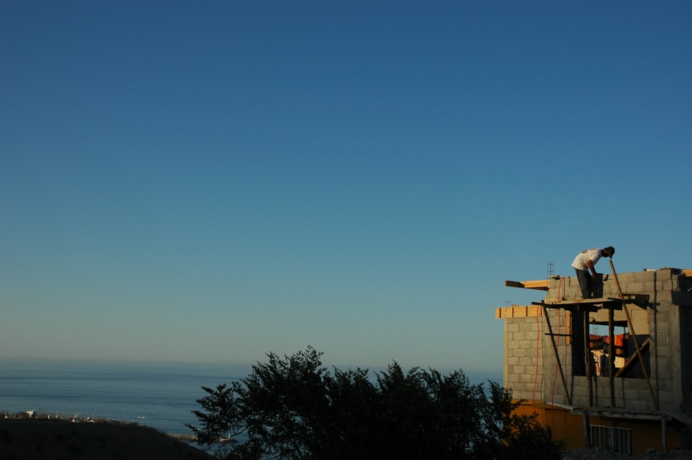 a man on top of a building under construction