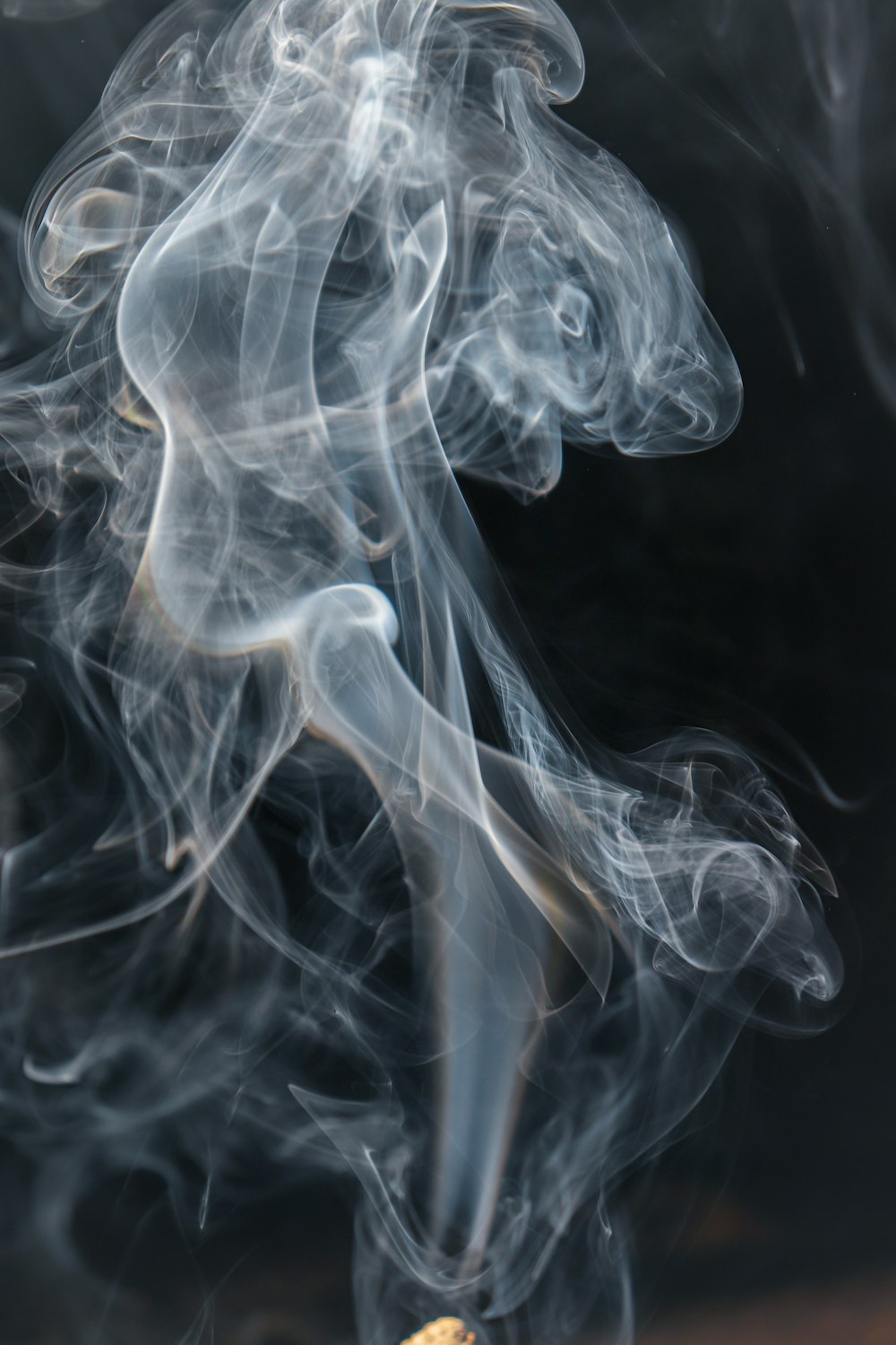 a close up of a cigarette with smoke coming out of it