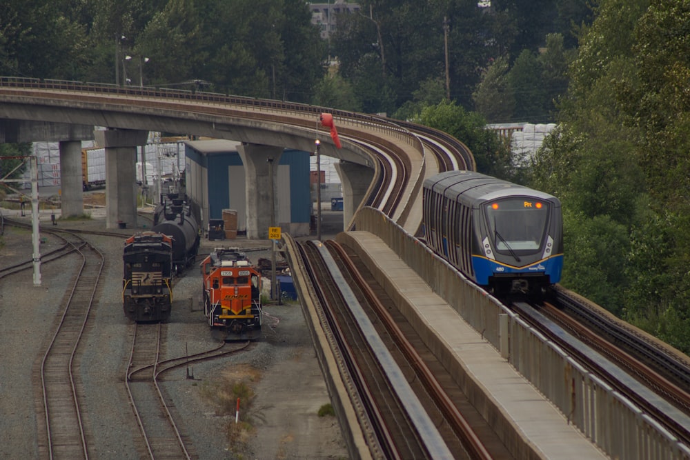 a train traveling down train tracks next to a forest