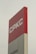 A tall sign with the letters 'CPKC' in bold white font on a red background. Below it, there is a partial view of a grey section with the text 'Vancouver'. The sign has a clean, modern appearance and stands against a cloudy sky.