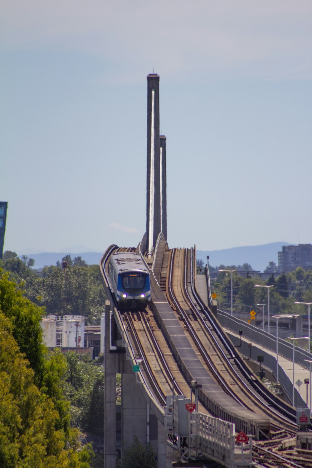 a train traveling over a bridge next to a forest