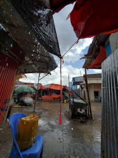 Street vendor packing up early as storm clouds gather overhead.