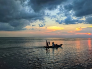 Seniors enjoying a serene boat ride at sunset, surrounded by calm waters.