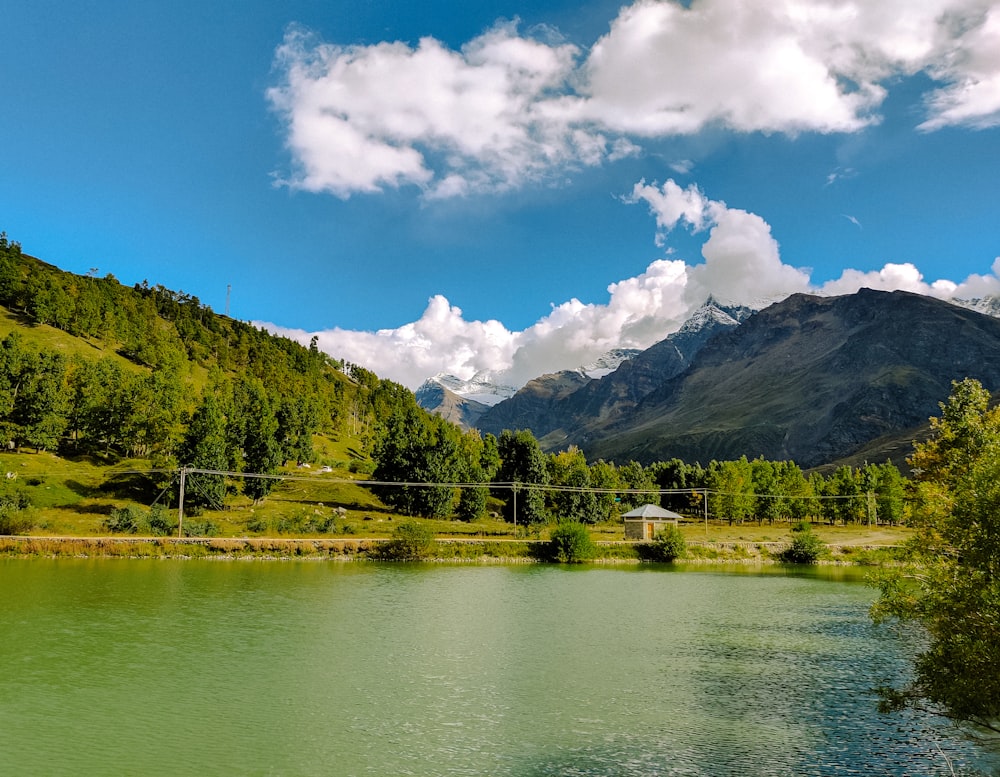 a body of water with mountains in the background