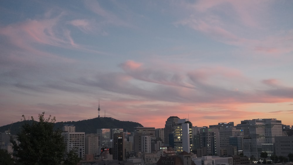 a view of a city at sunset with clouds in the sky