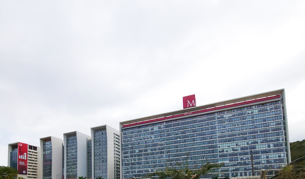 a tall building with a red m on top of it