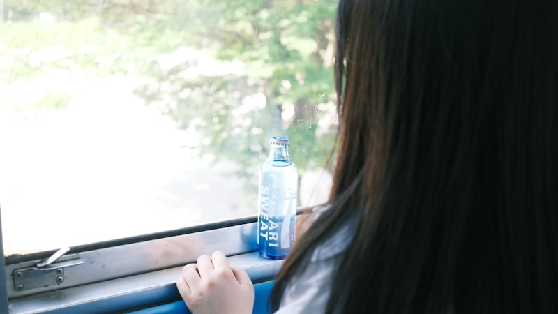 Woman sitting on a train, gazing out a window