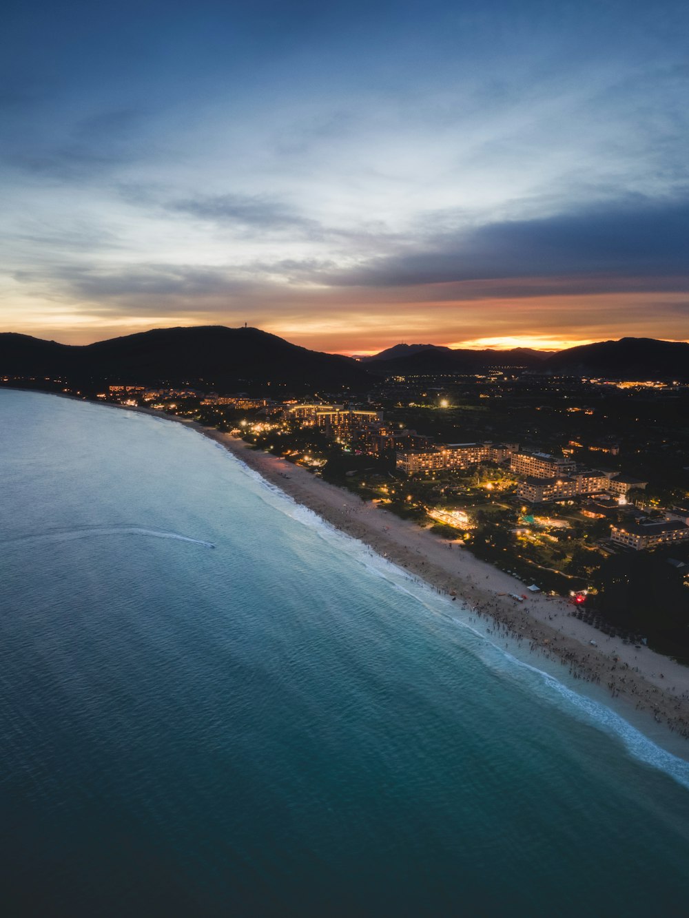 an aerial view of a beach at night