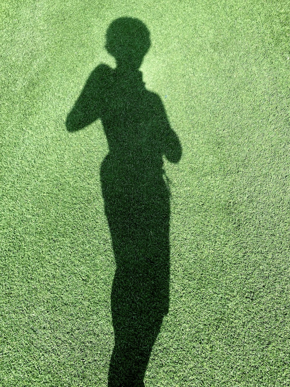 a shadow of a person holding a baseball bat
