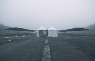 Close-up of a fumigation tent covering a warehouse during pest extermination at dusk.
