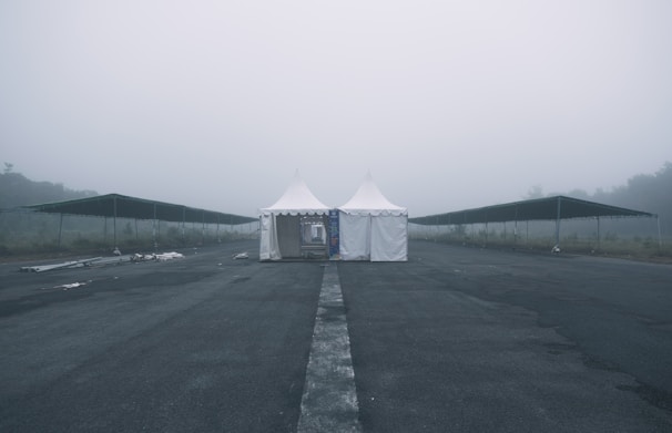 Close-up of a fumigation tent covering a warehouse during pest extermination at dusk.