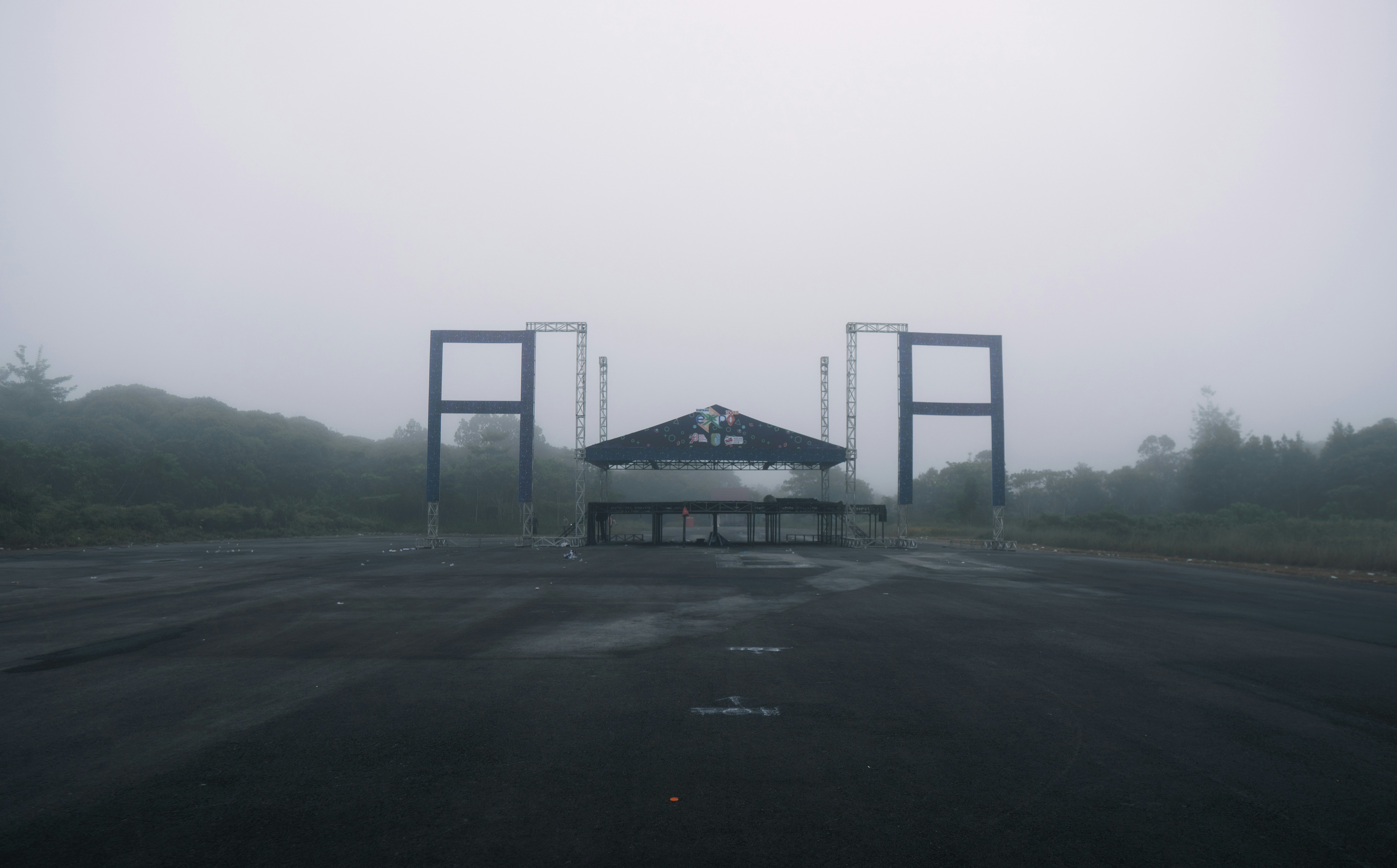 a foggy parking lot with two large gates