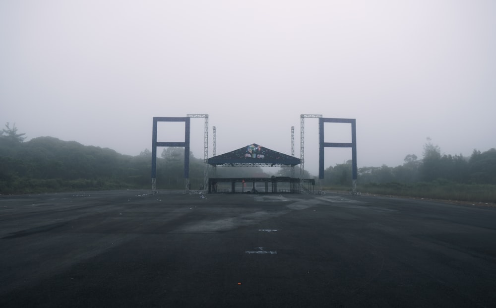 a foggy parking lot with two large gates