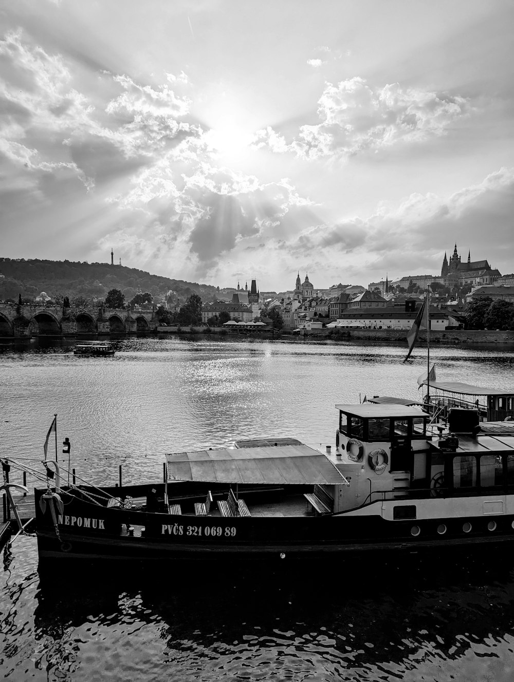 a black and white photo of a boat in the water