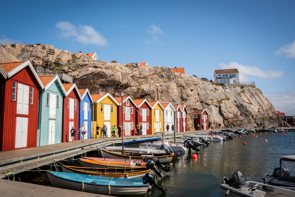 a row of colorful beach huts next to a body of water