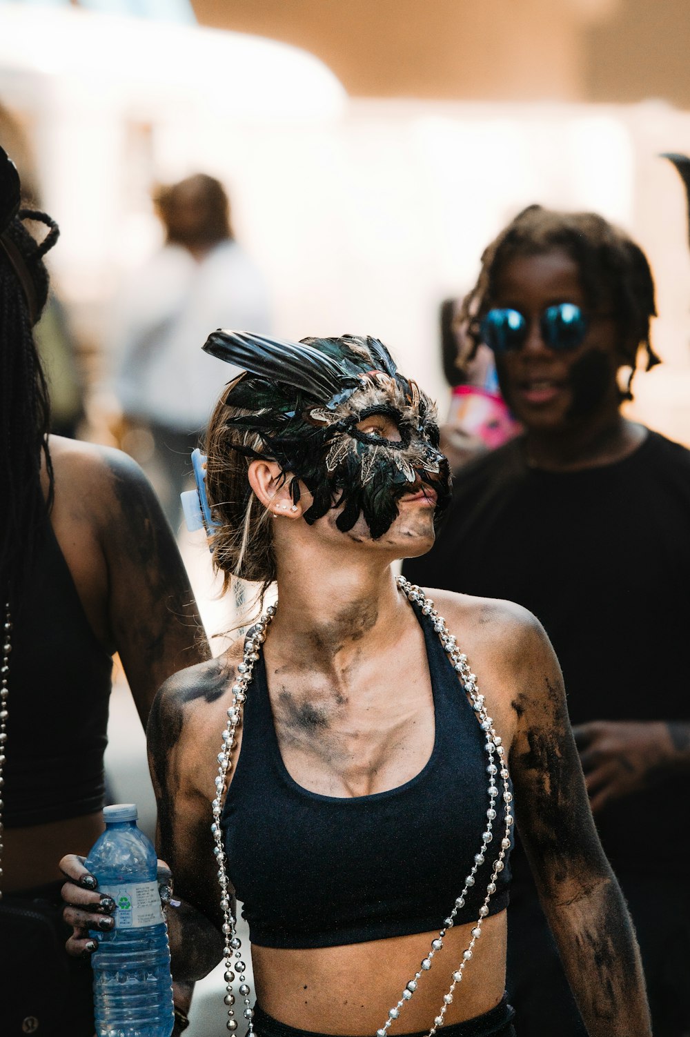 a woman in a black top with a chain around her neck