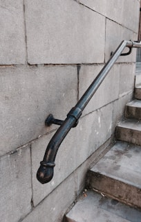 Close-up of a sturdy metal handrail with earth-tone paint.