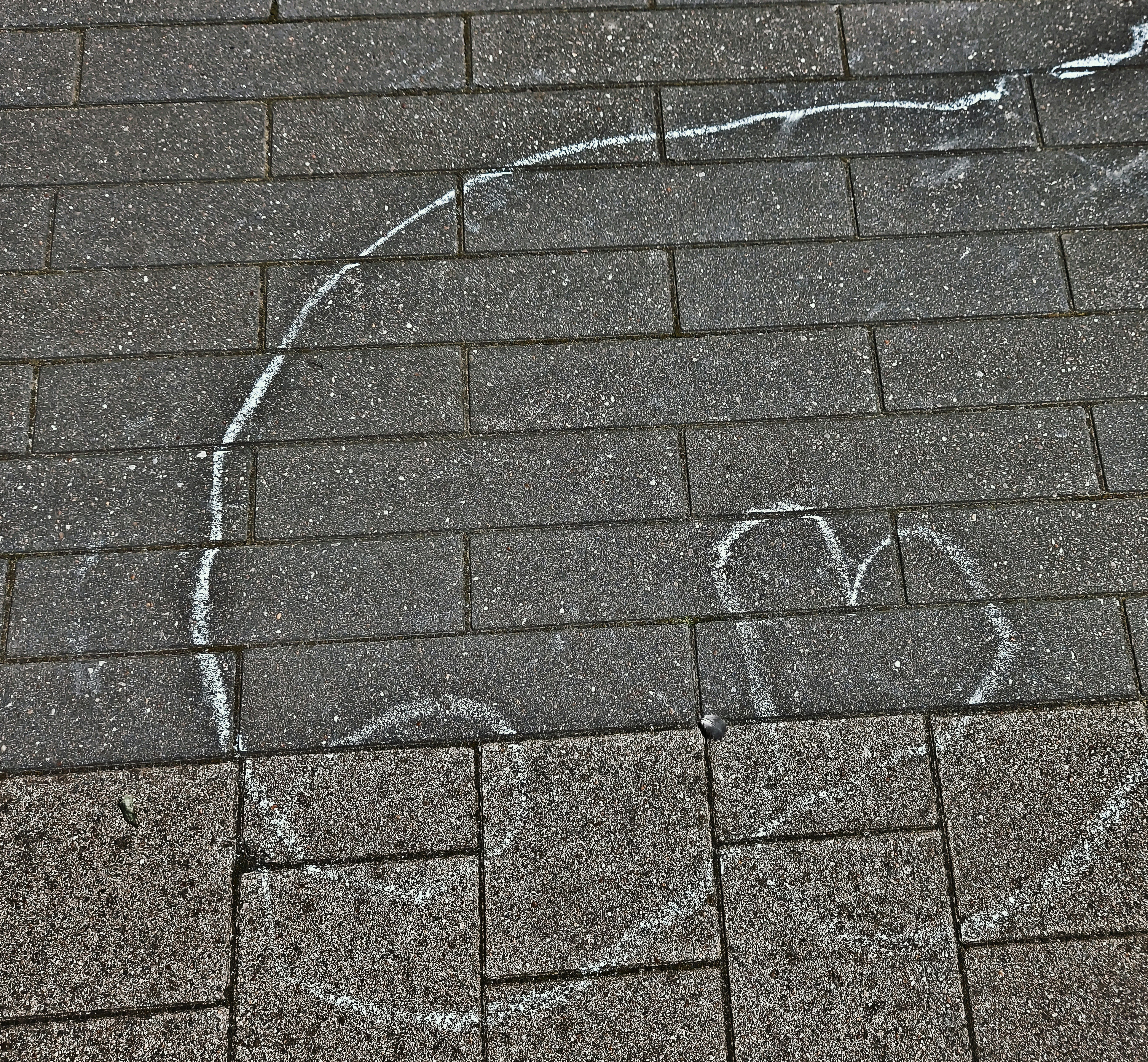 a heart drawn on the sidewalk with chalk