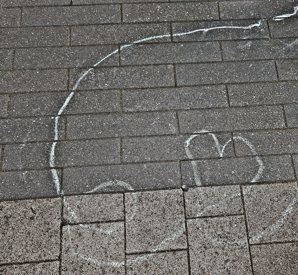 a heart drawn on the sidewalk with chalk