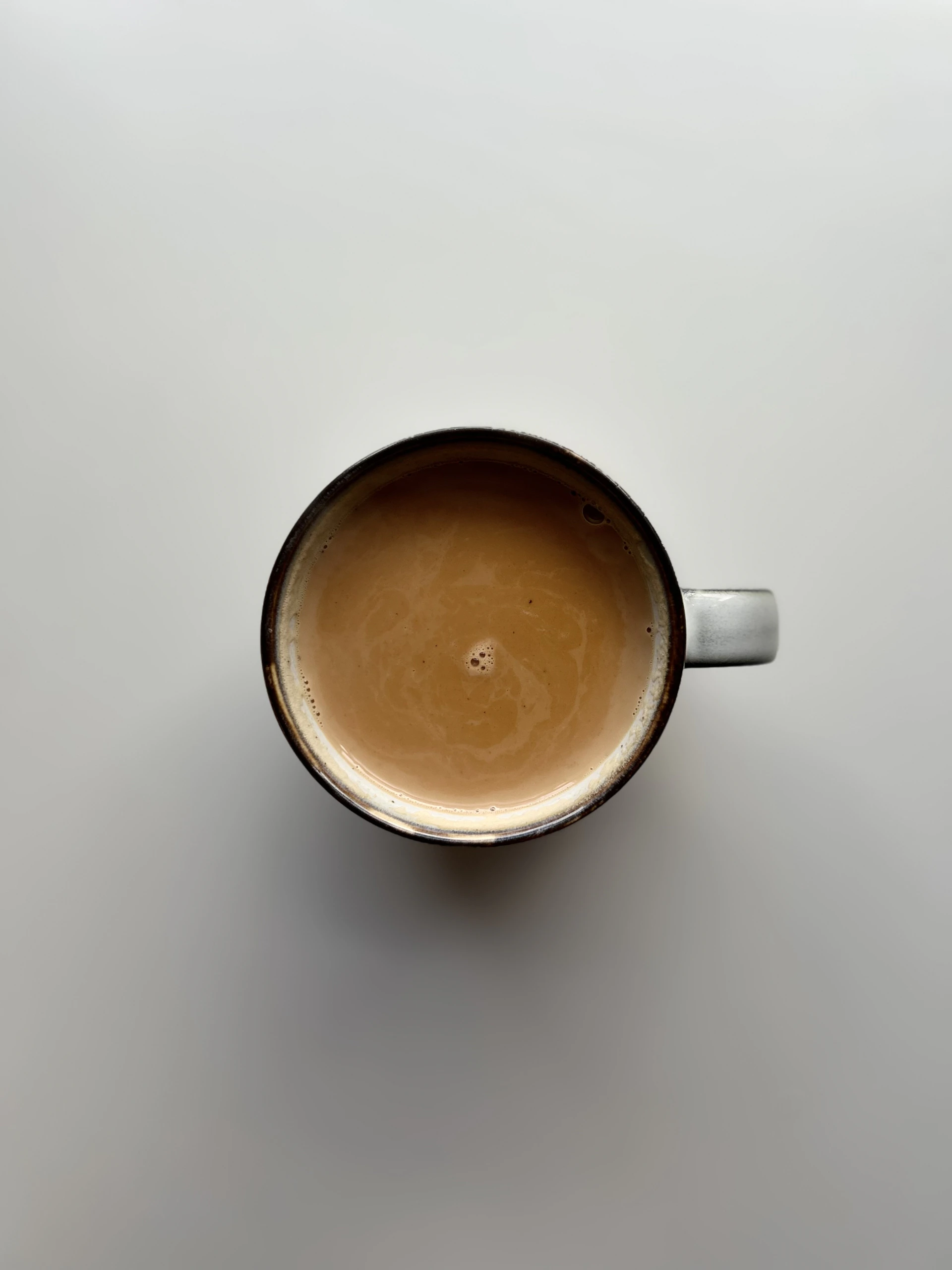 a cup of coffee sitting on top of a table