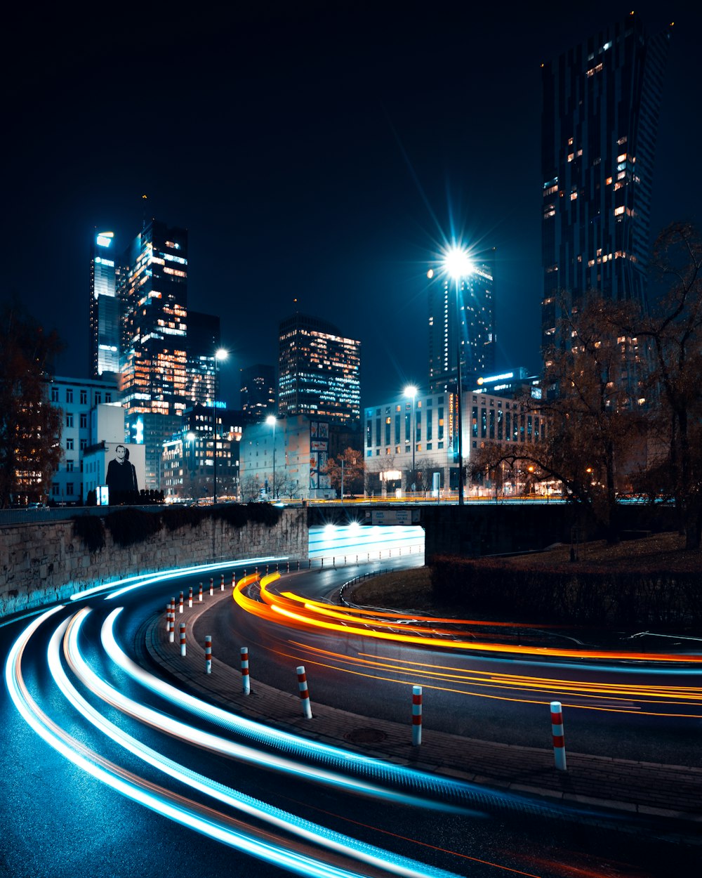 a city at night with light streaks on the road