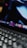 Close-up of hands typing on a laptop keyboard with cloud icons floating above.