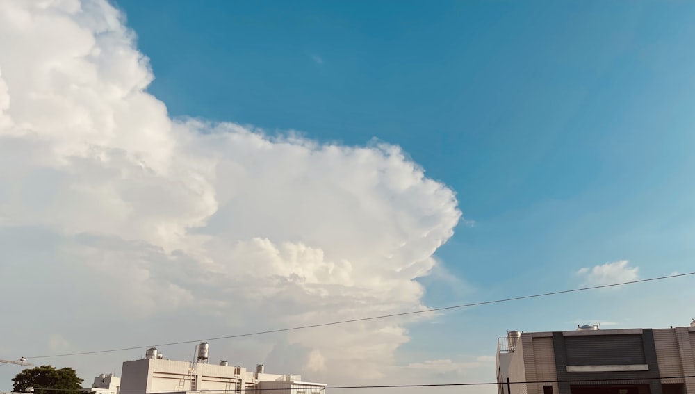 a large cloud is in the sky over a building