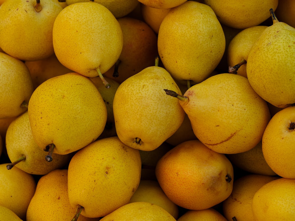 a pile of yellow pears sitting next to each other