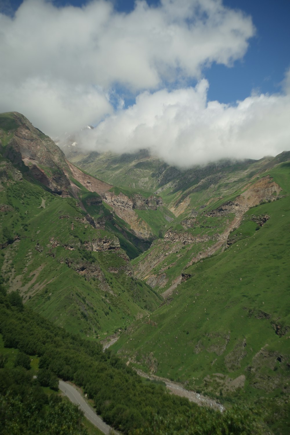 a view of a valley with mountains in the background