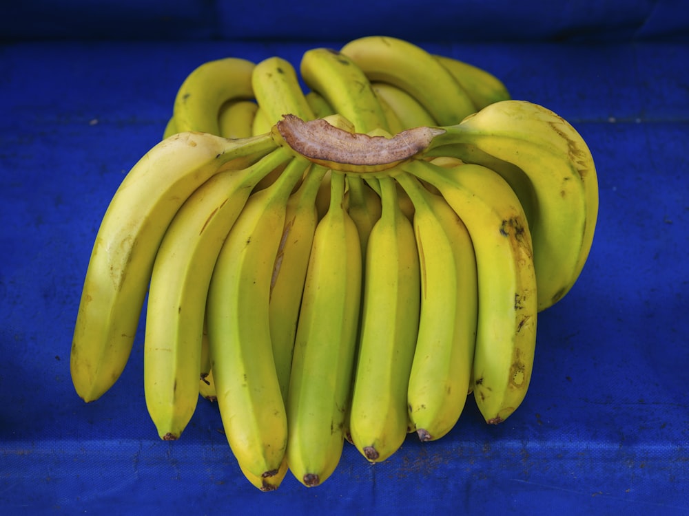 a bunch of bananas sitting on top of a blue table
