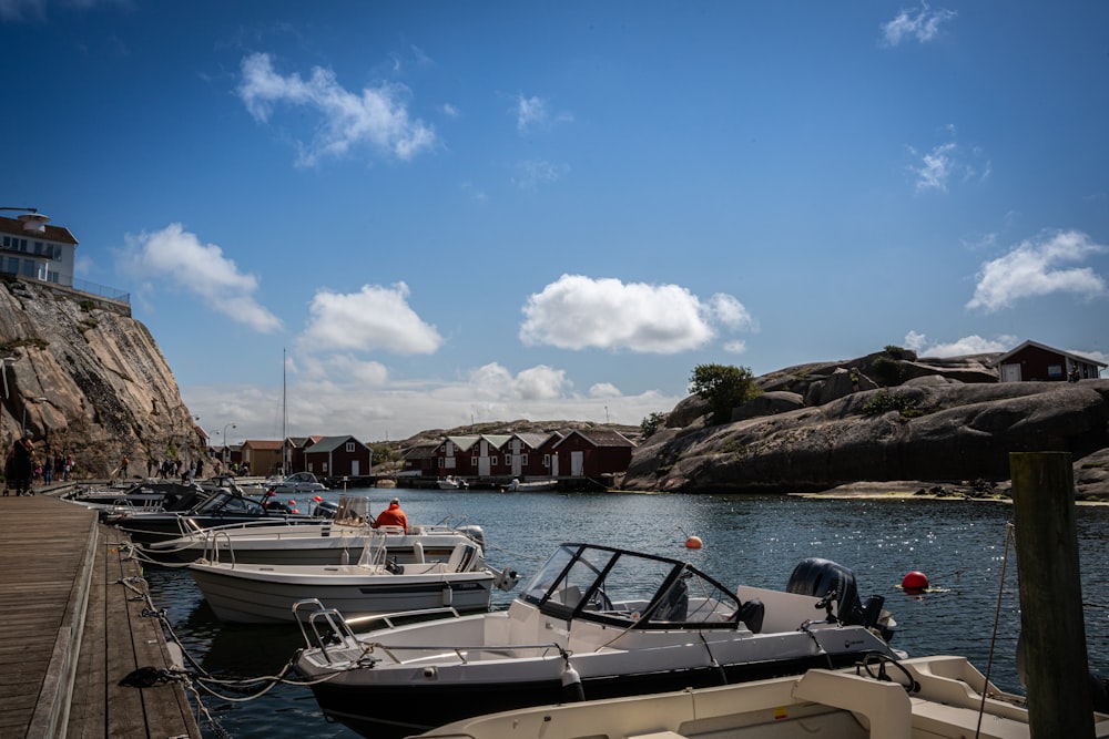 a group of boats parked next to a dock