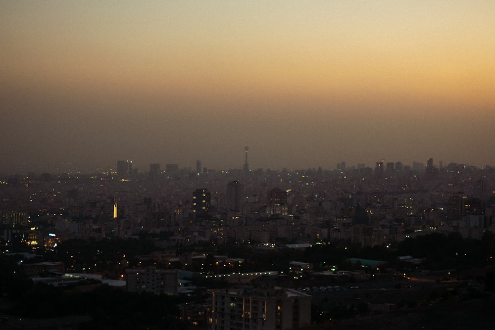 a view of a city at night from a hill