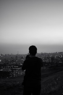 An artistic shot of a photographer capturing a cityscape.