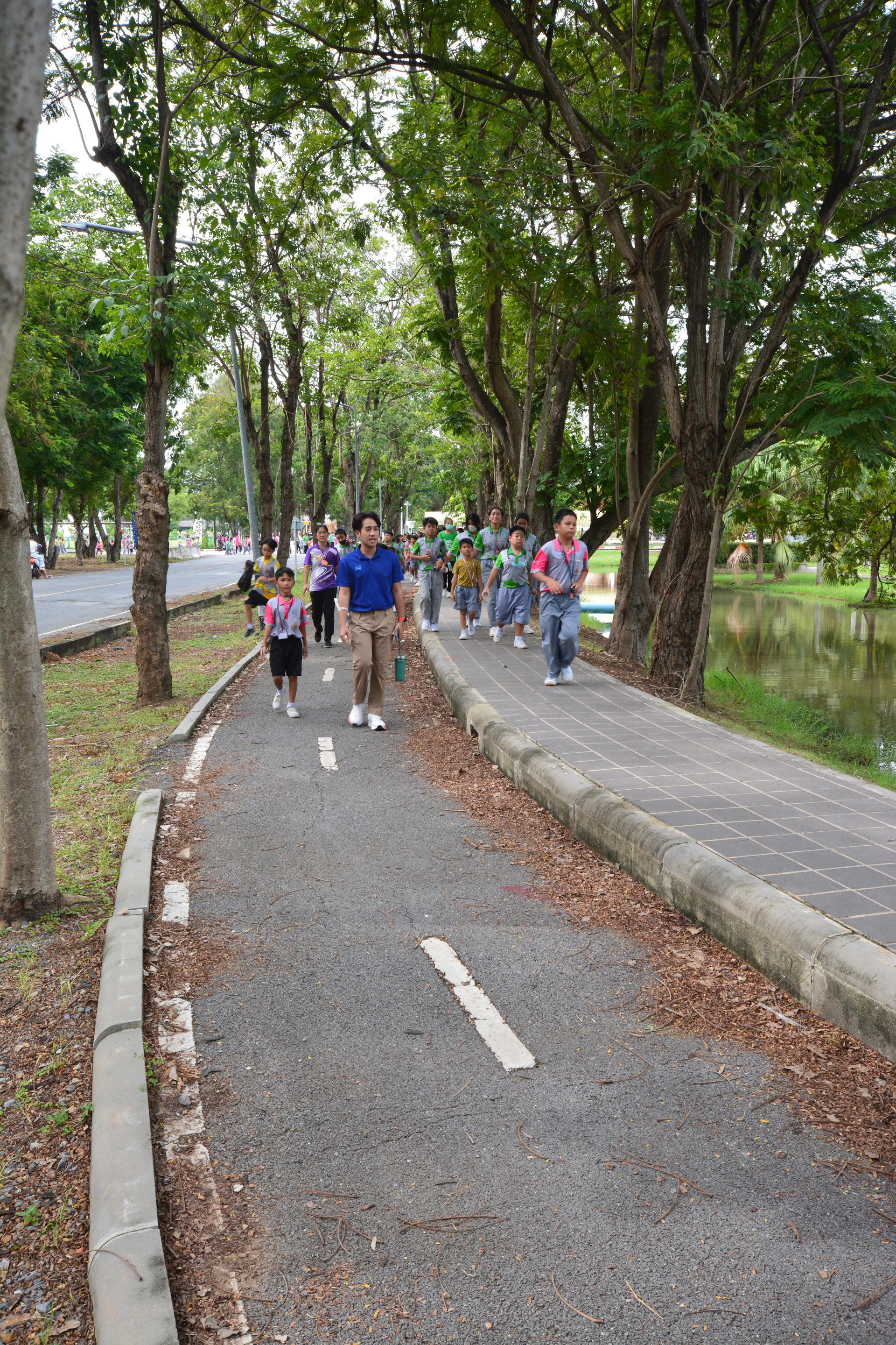 Smiling tourists enjoying a guided tour in a lush tropical garden of Batam.