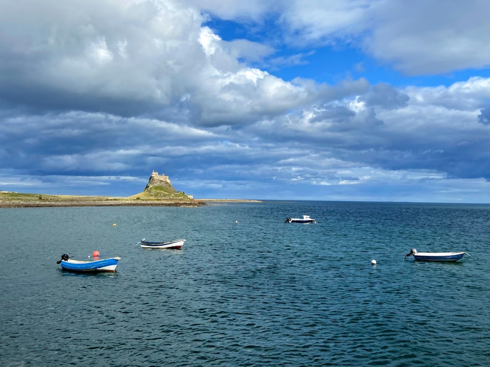 a group of boats floating on top of a large body of water