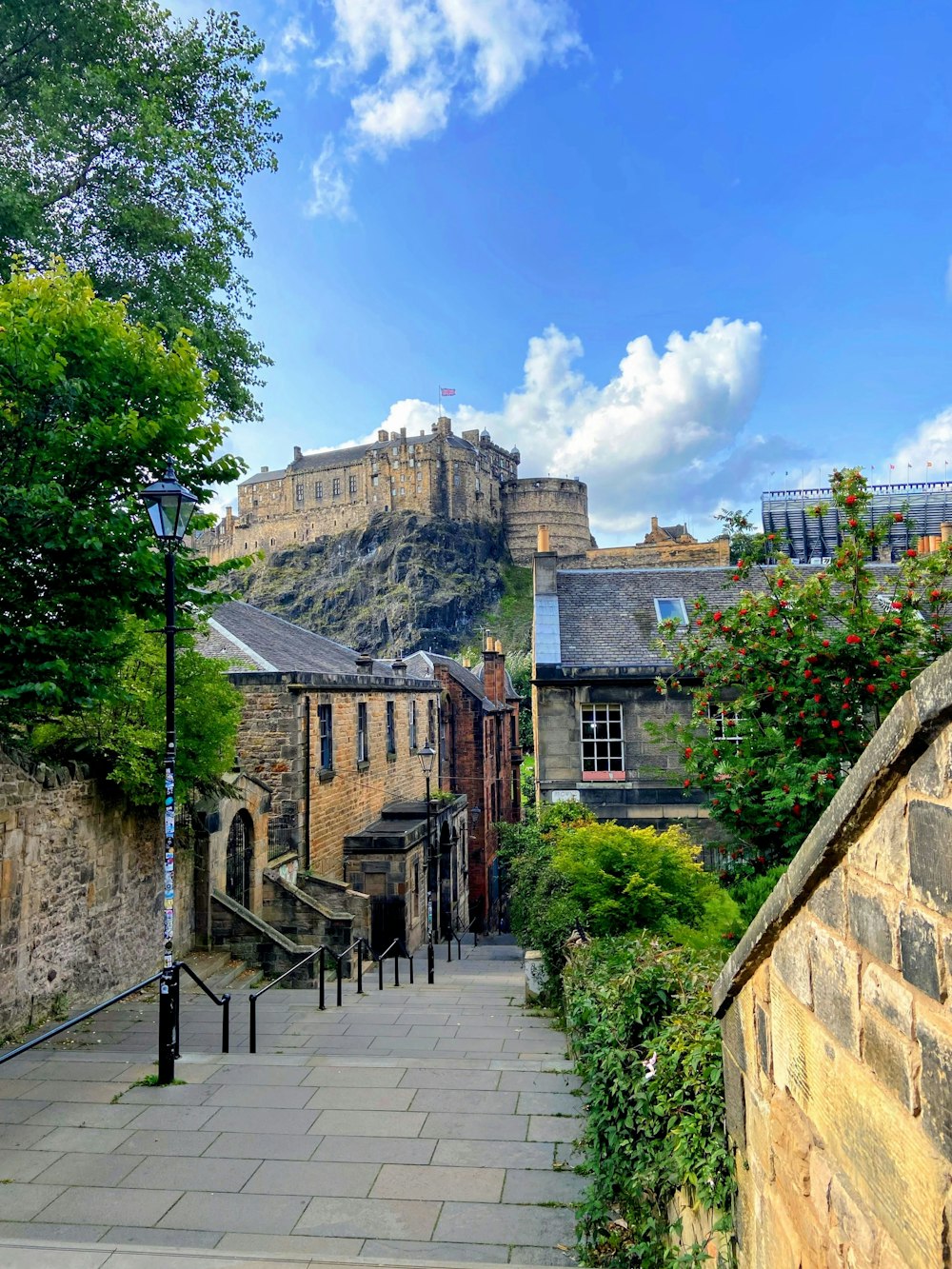 a stone walkway with a castle in the background