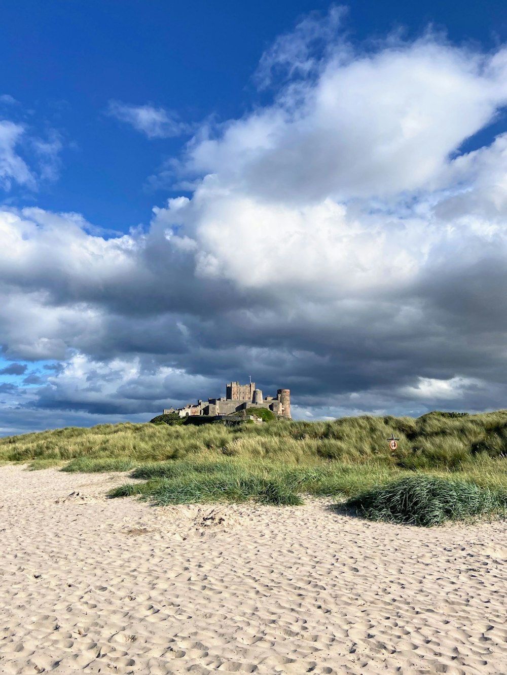 a castle sitting on top of a sandy beach