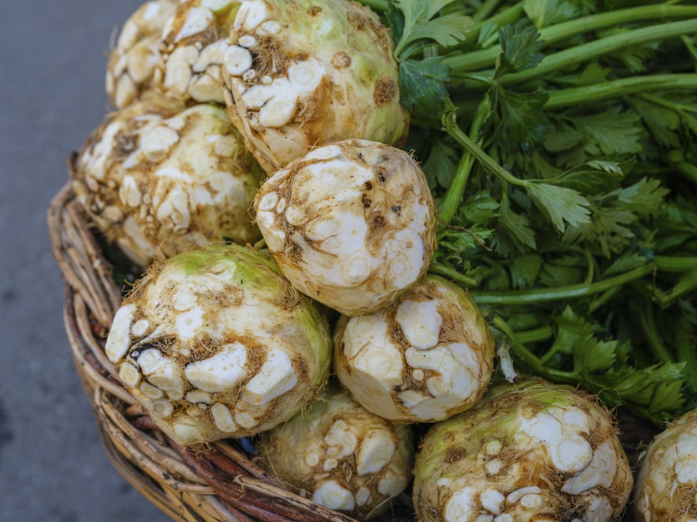 a basket filled with lots of green vegetables