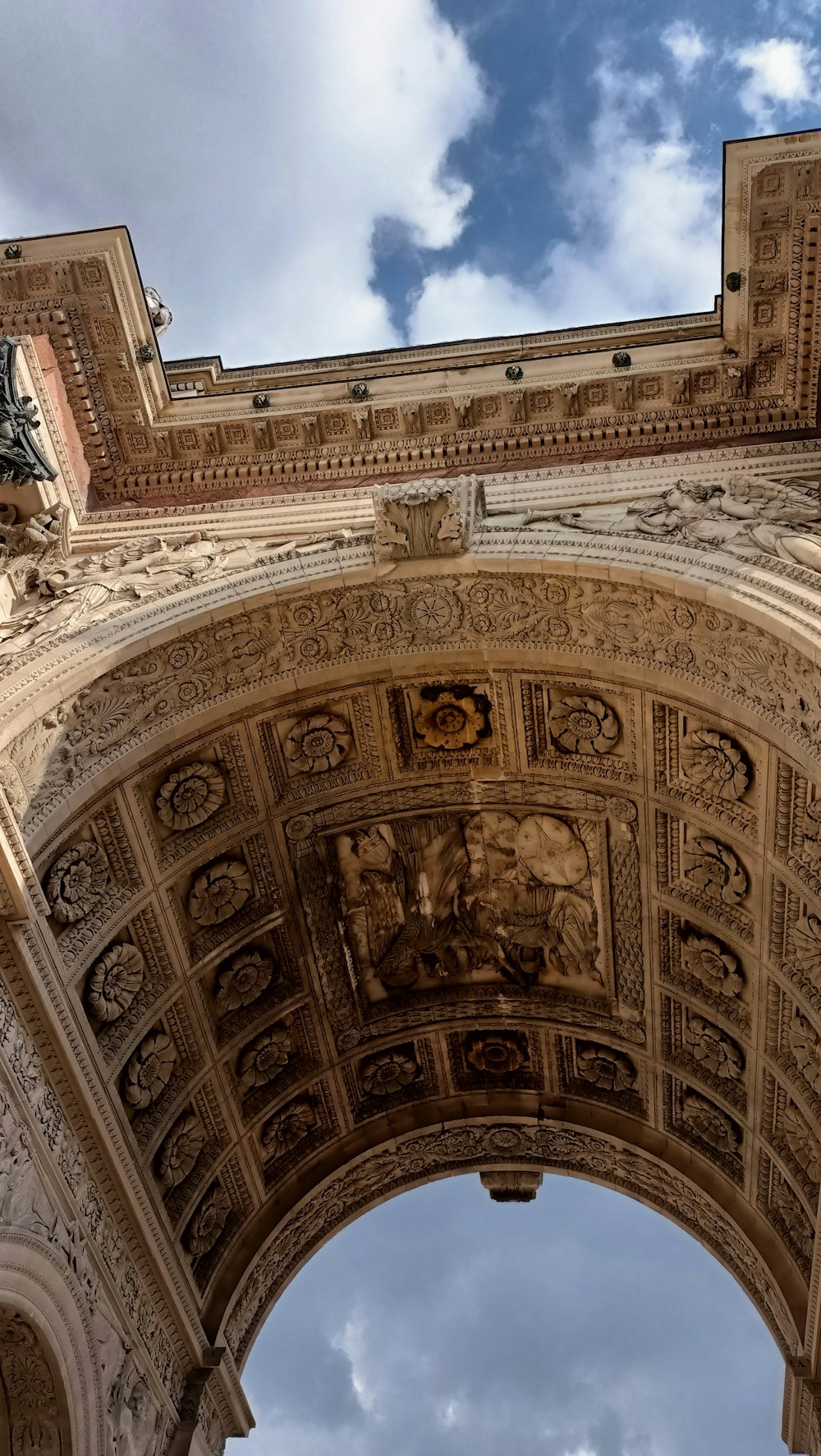 a very tall arch with a clock on it