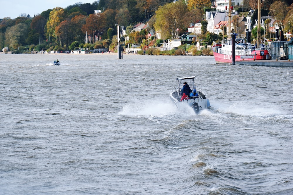 a man riding a boat on top of a body of water