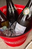 Elegant white wine bottles chilling in an ice bucket on a modern table.